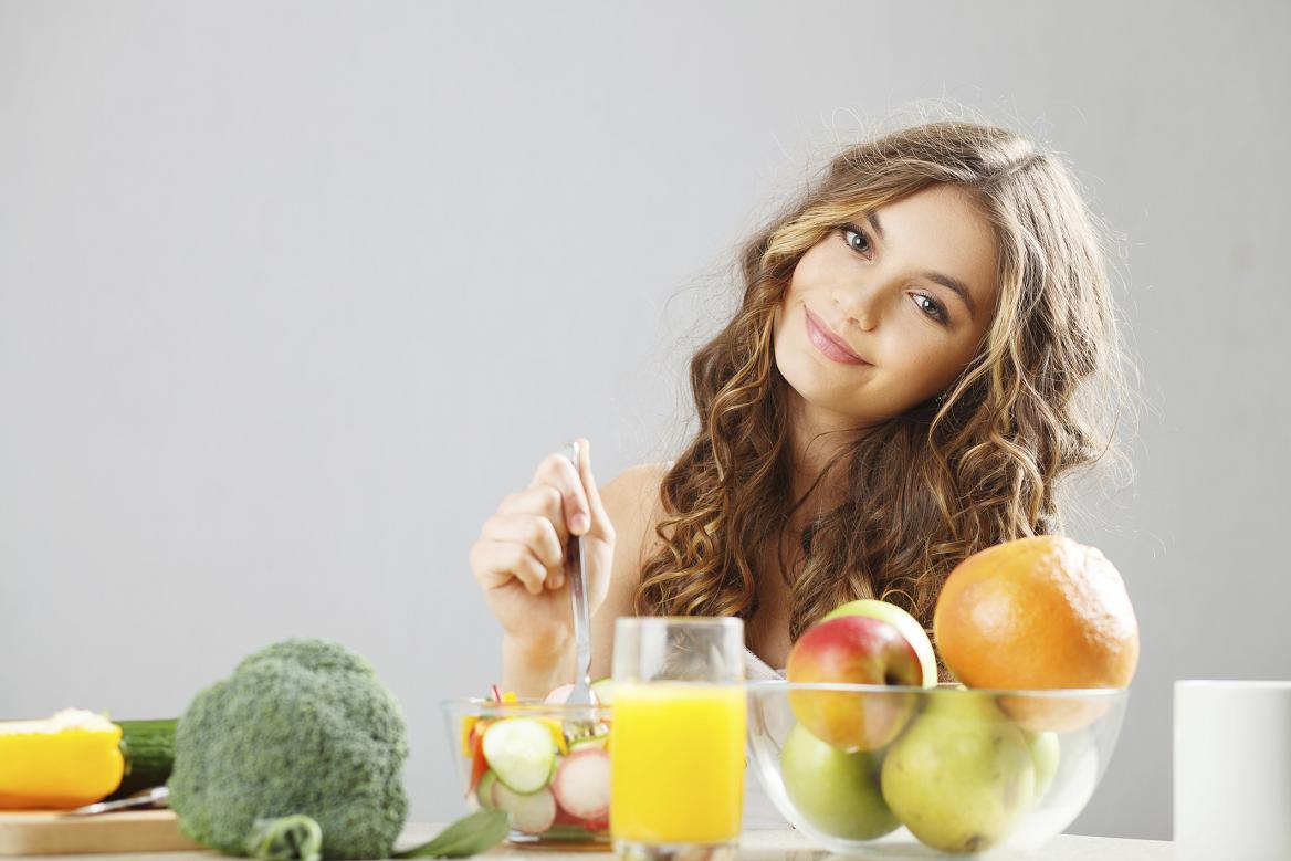 Young cute girl having breakfast