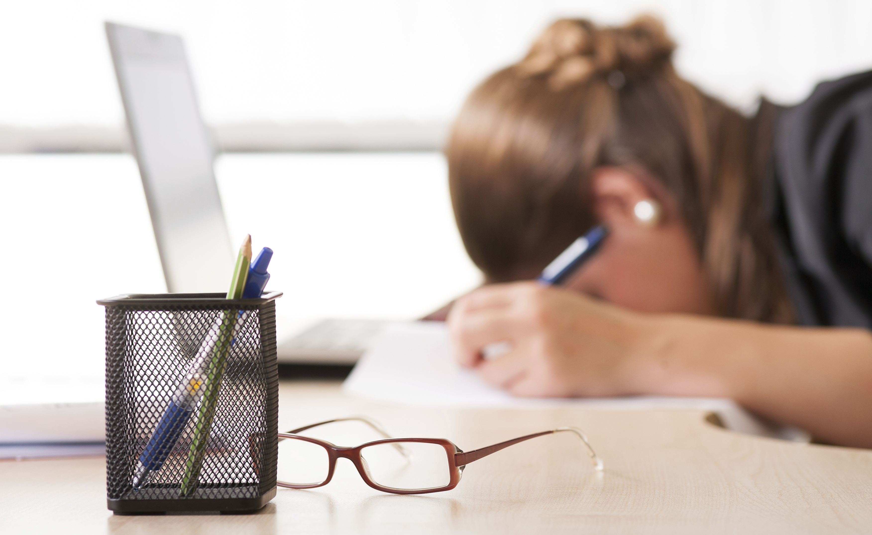 Exhausted woman sleeping at work